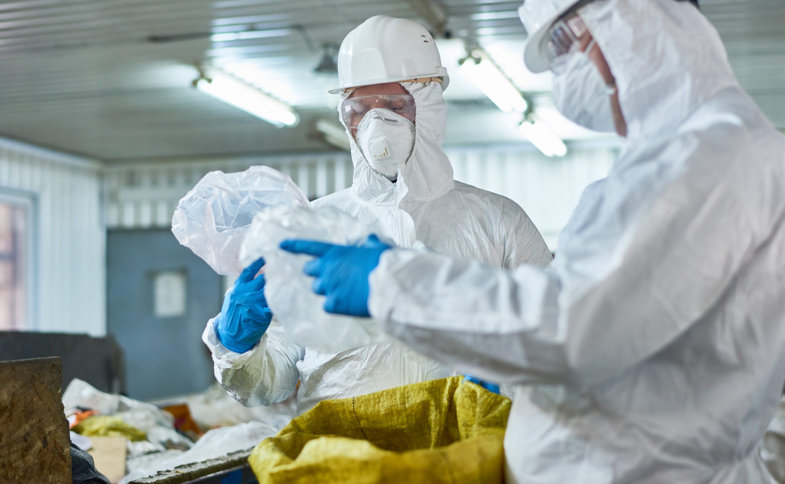 Workers Sorting Plastic on Modern Waste Processing Plant